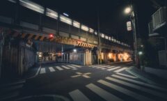 Train passing over a street crossing at night