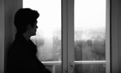 A person standing in front of a window